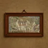 Red roofs, corner of a village, winter-frame by Camille Pissarro